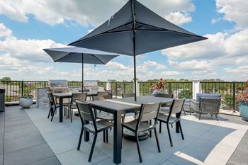 a patio with tables and chairs and umbrellas